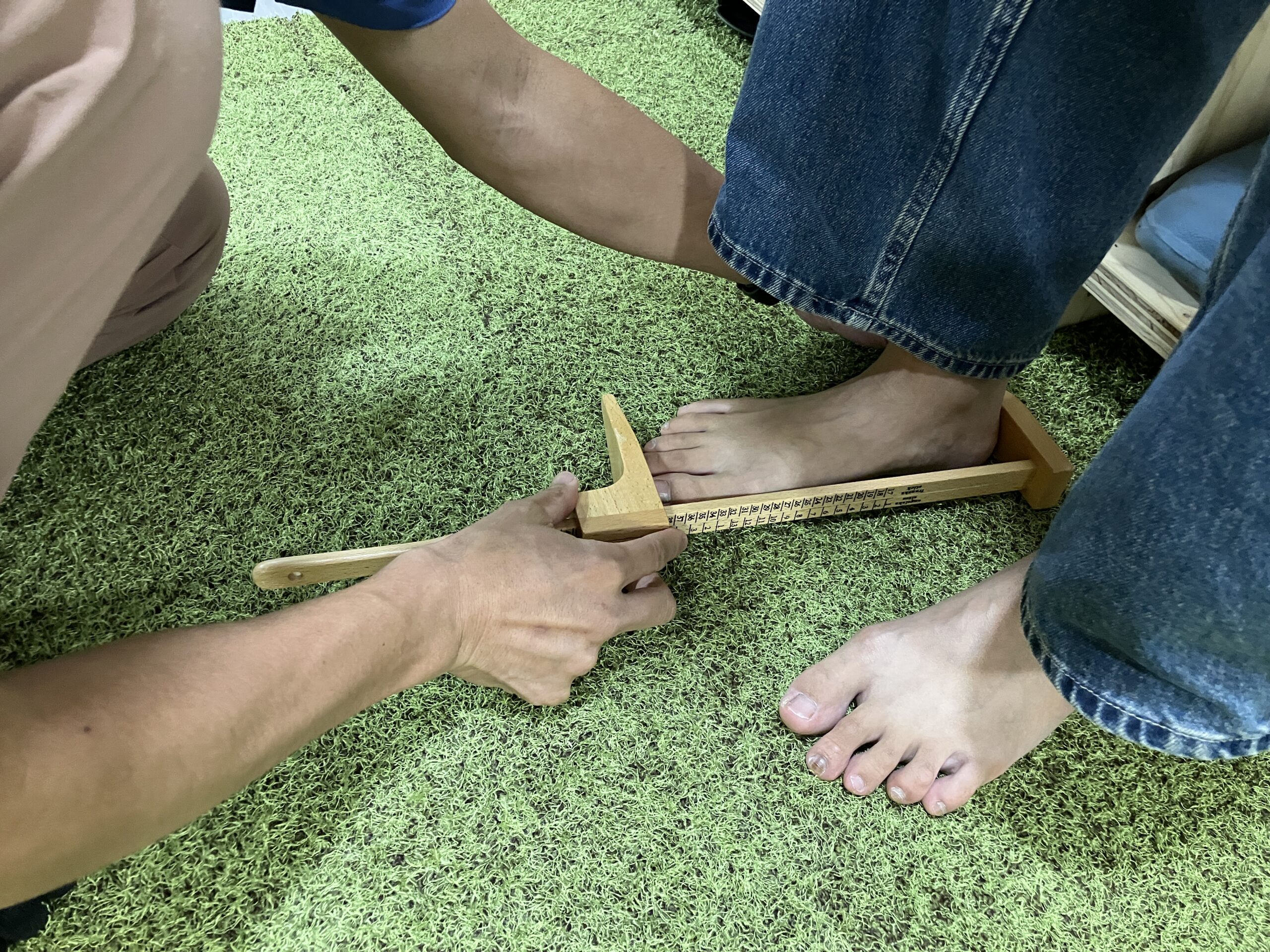 足の長さや幅を専用の器具ではかる様子｜BALANCECARE 接骨院 らくだ